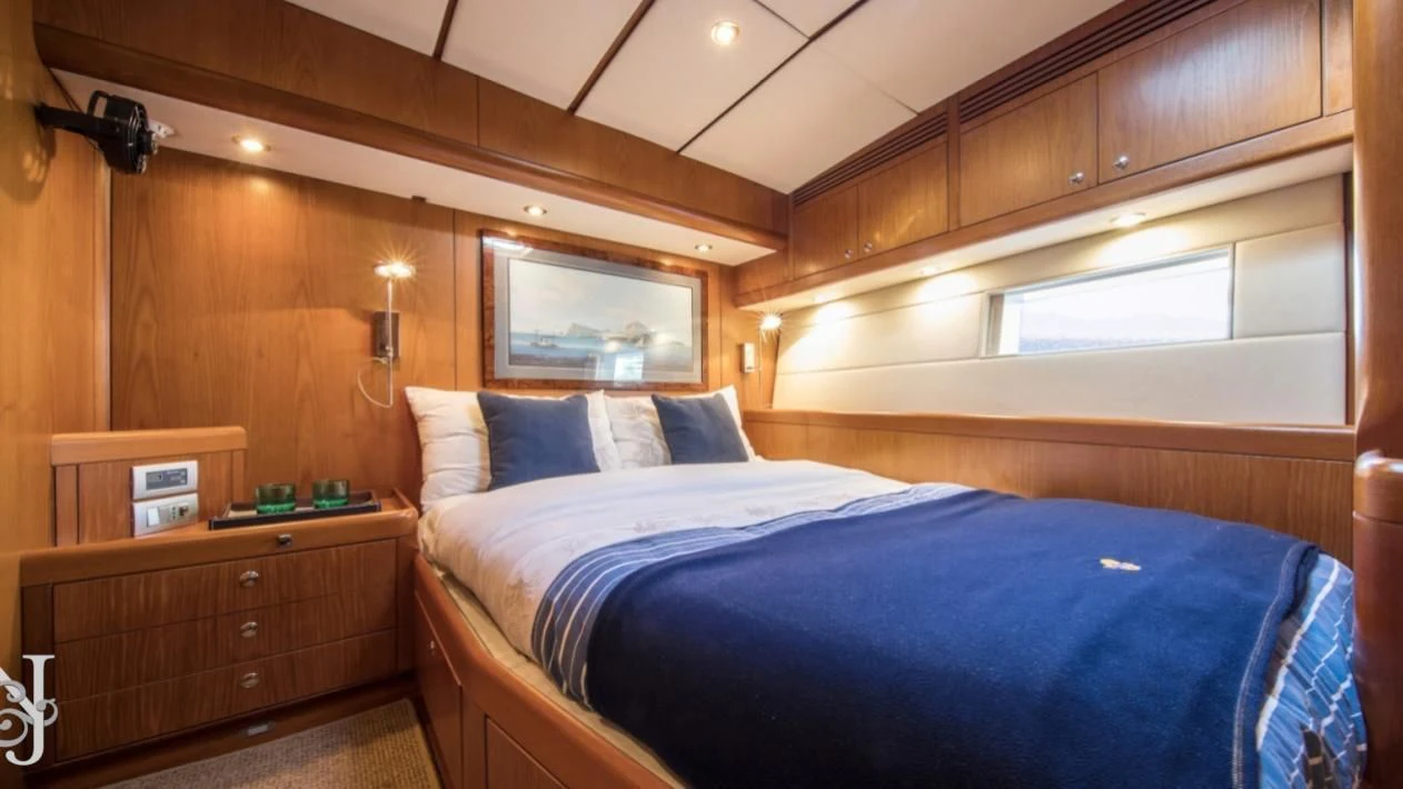 a bed with a blue comforter aboard MEDUSA Yacht for Sale