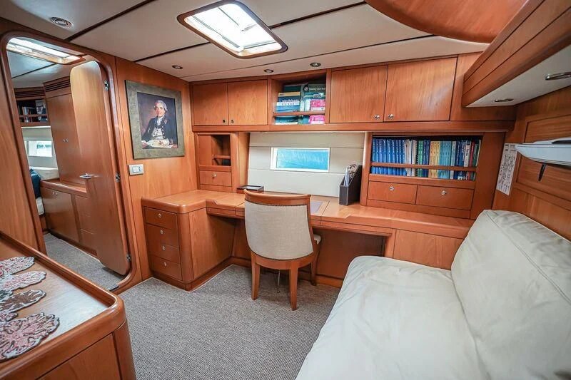 a living room with a couch and a bookcase aboard MEDUSA Yacht for Sale