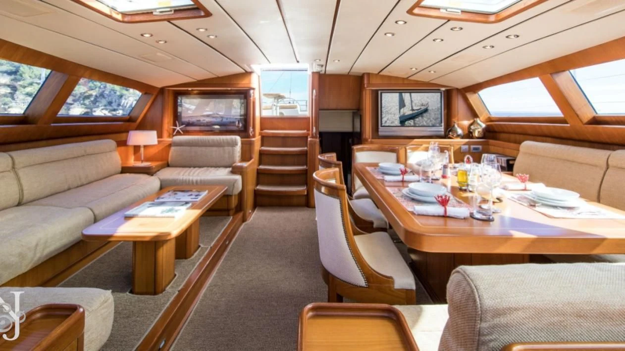a living room with a table and chairs aboard MEDUSA Yacht for Sale