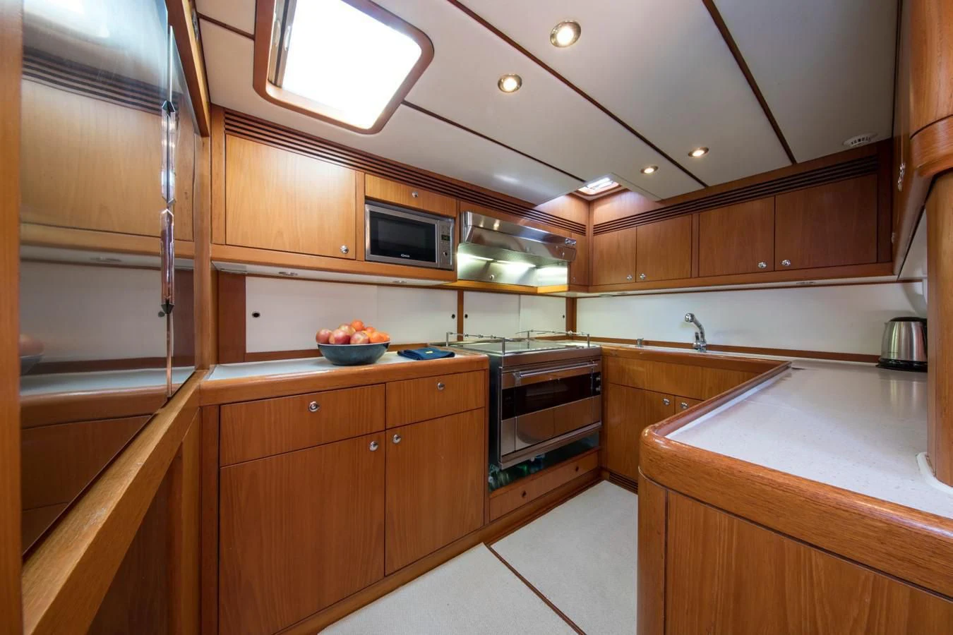 a kitchen with wooden cabinets aboard MEDUSA Yacht for Sale