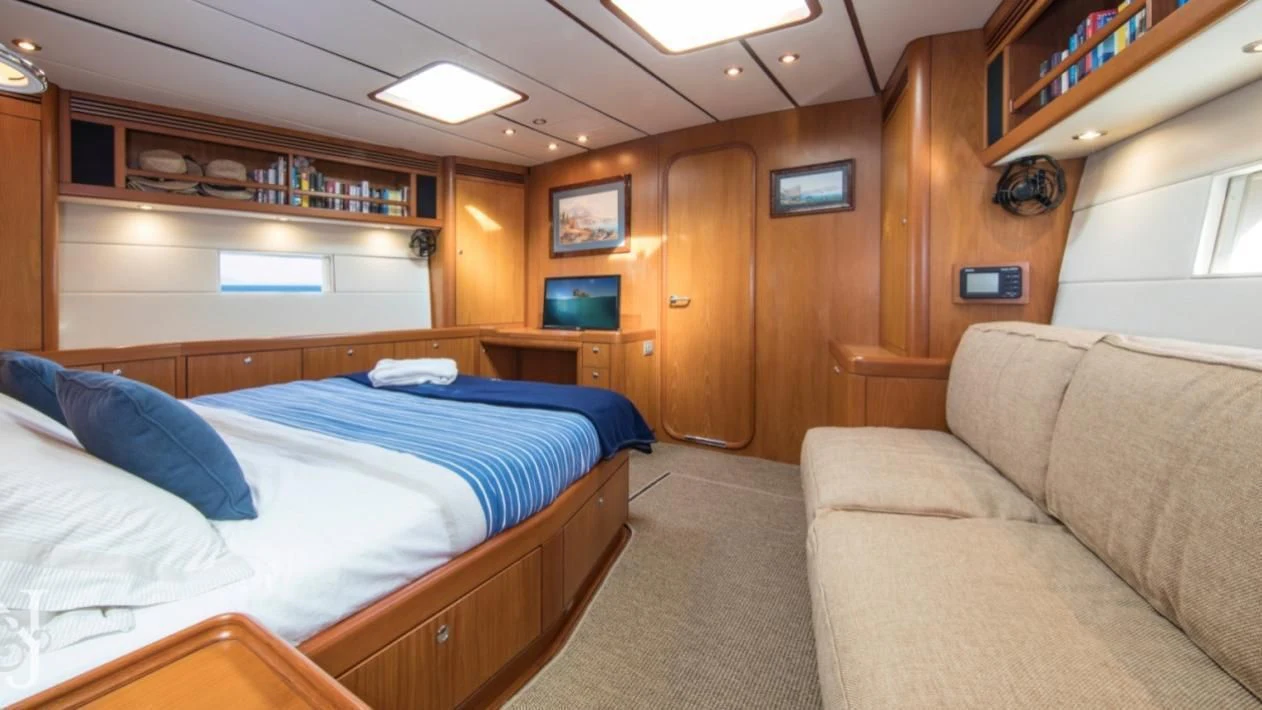 a bedroom with a bed and a couch aboard MEDUSA Yacht for Sale