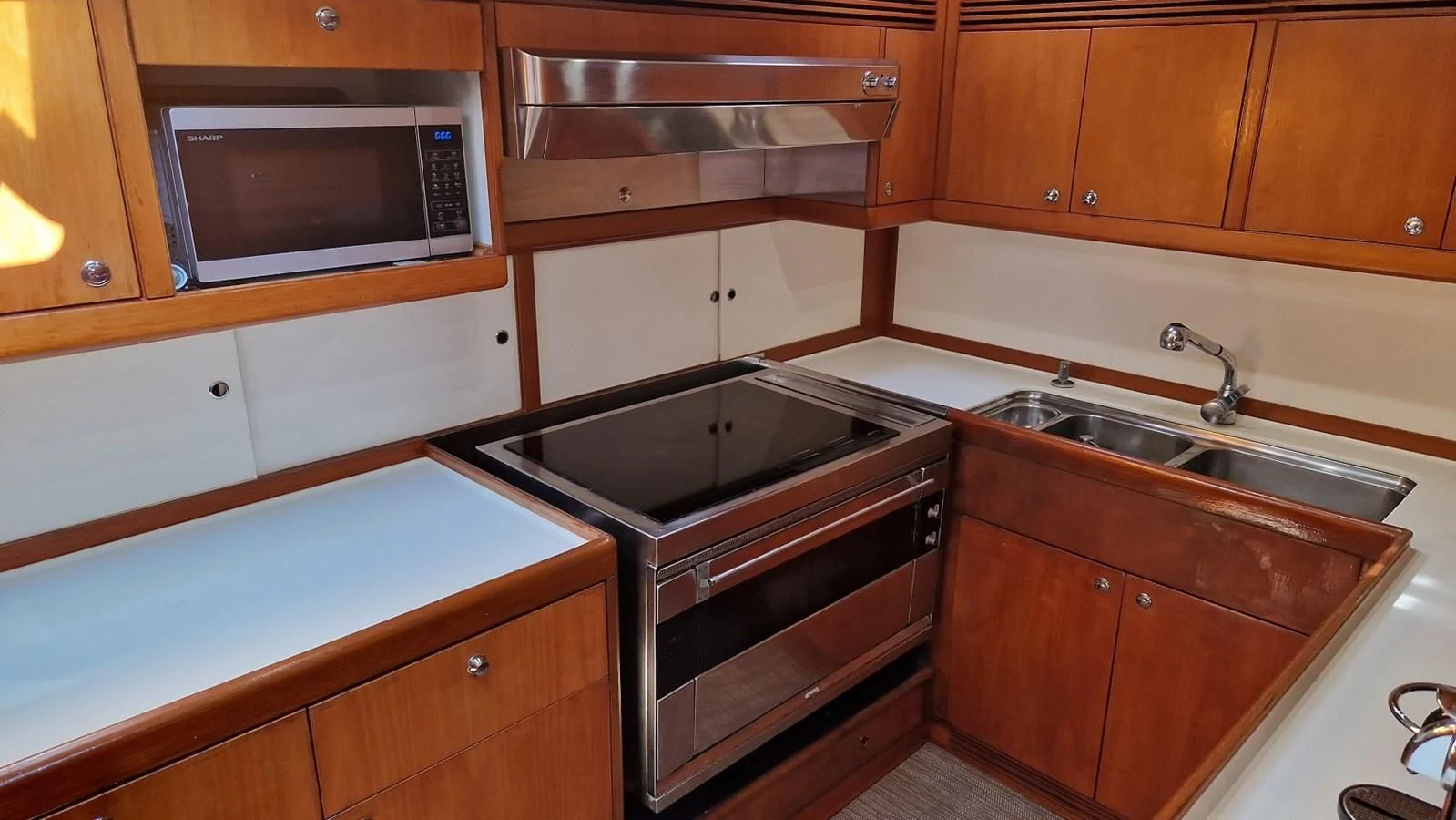 a kitchen with wooden cabinets aboard MEDUSA Yacht for Sale