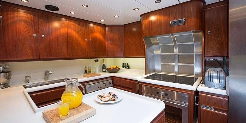 a kitchen with wooden cabinets aboard INFATUATION Yacht for Sale