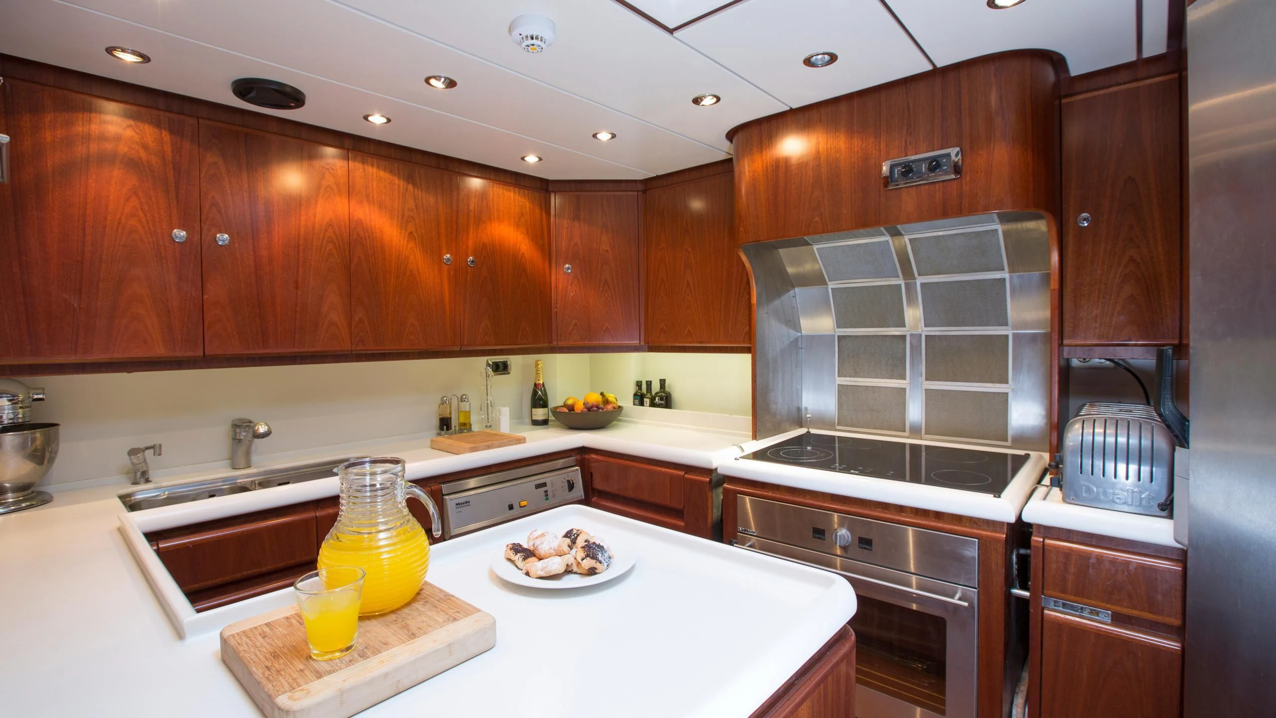 a kitchen with wooden cabinets aboard INFATUATION Yacht for Sale