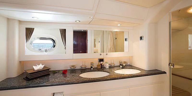 a bathroom with sinks and mirrors aboard INFATUATION Yacht for Sale