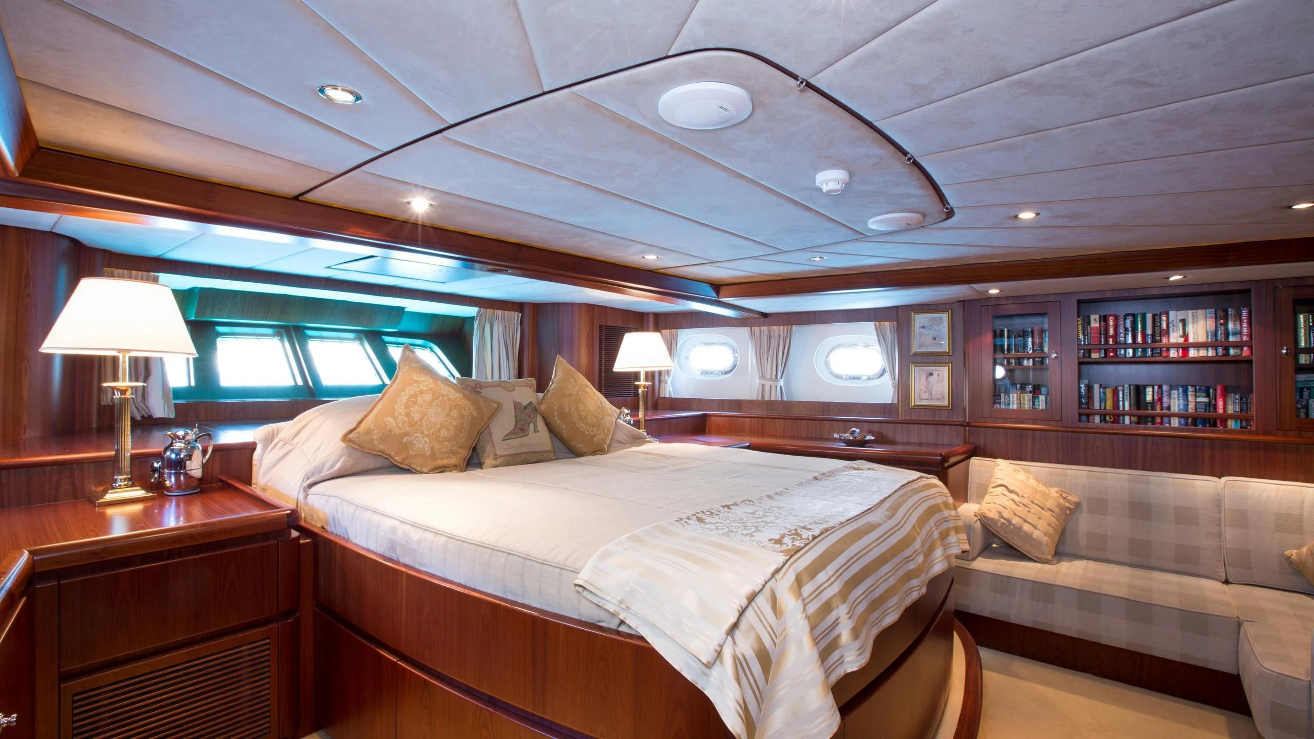 a bedroom with a bed and a couch aboard INFATUATION Yacht for Sale