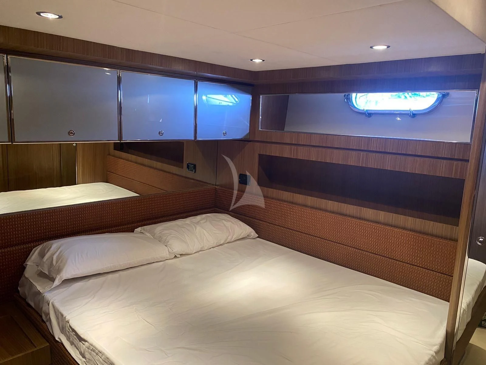 a room with a bed and a television aboard ALTER EGO Yacht for Sale