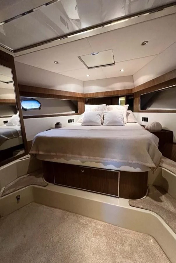 a bed with a white bed aboard ALTER EGO Yacht for Sale