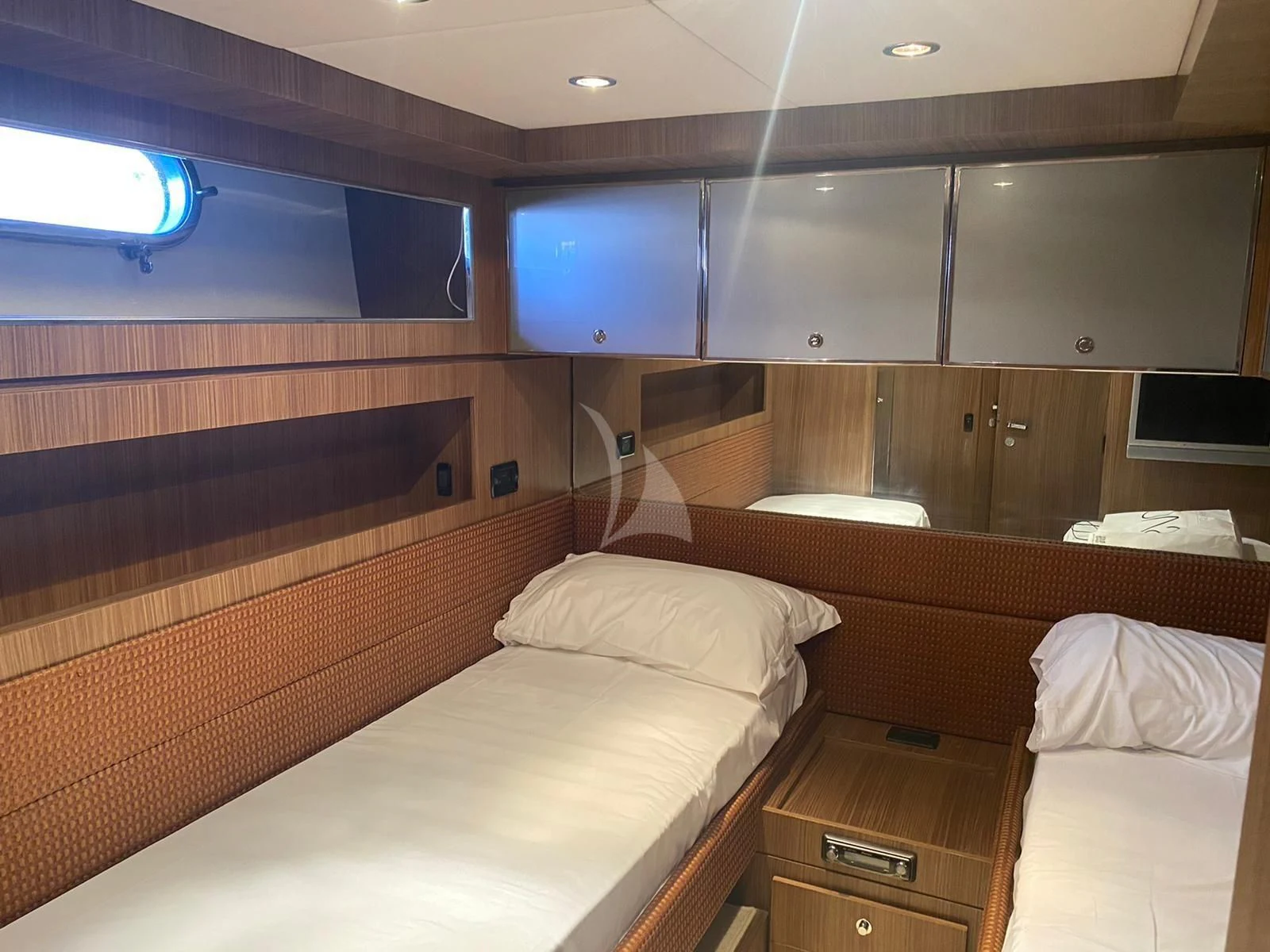 a room with beds and a television aboard ALTER EGO Yacht for Sale