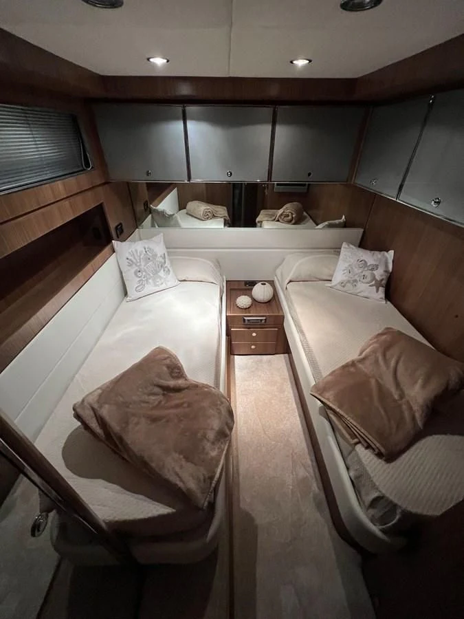 a room with a bed and a chair aboard ALTER EGO Yacht for Sale