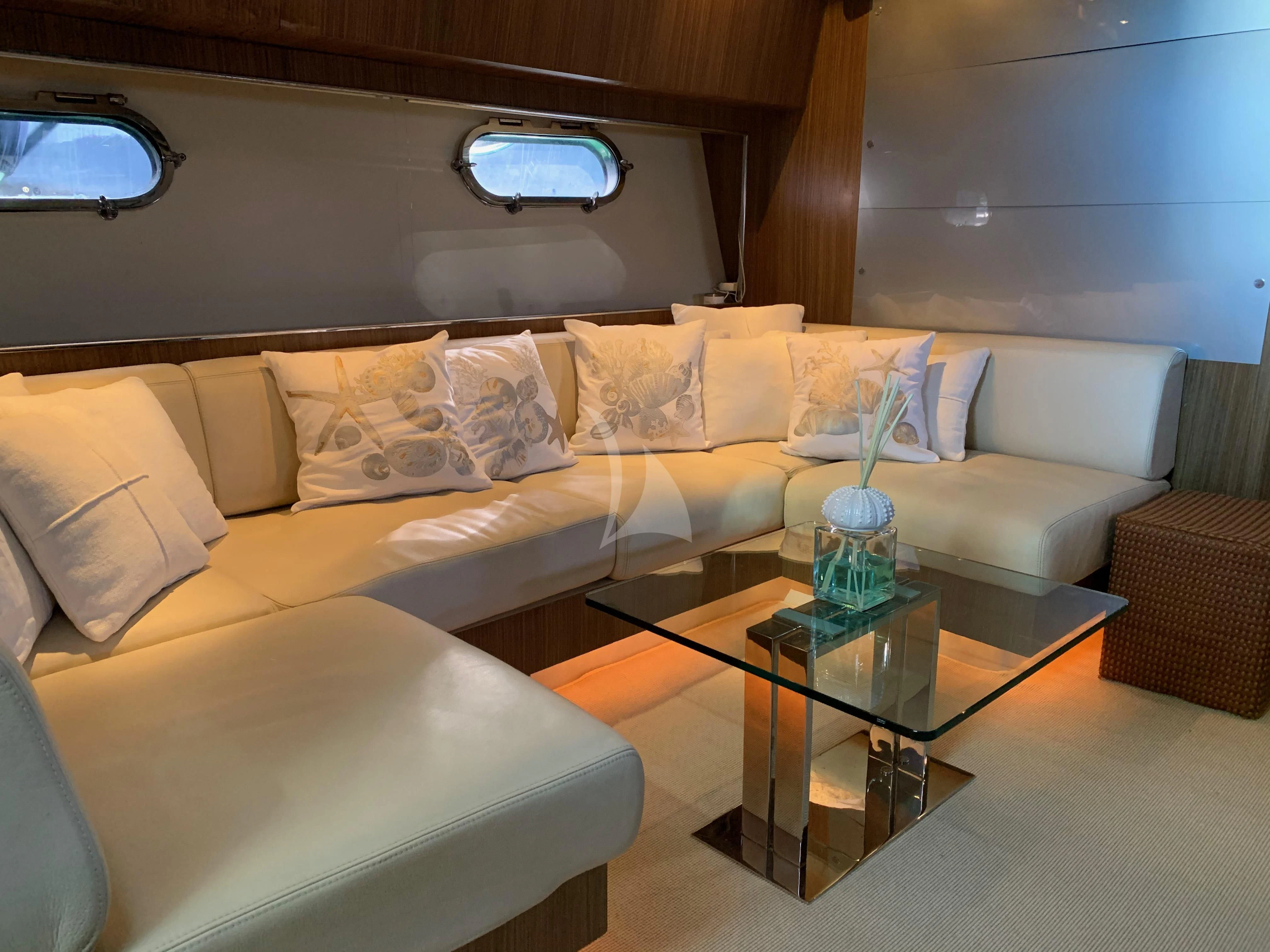 a living room with a couch and coffee table aboard ALTER EGO Yacht for Sale