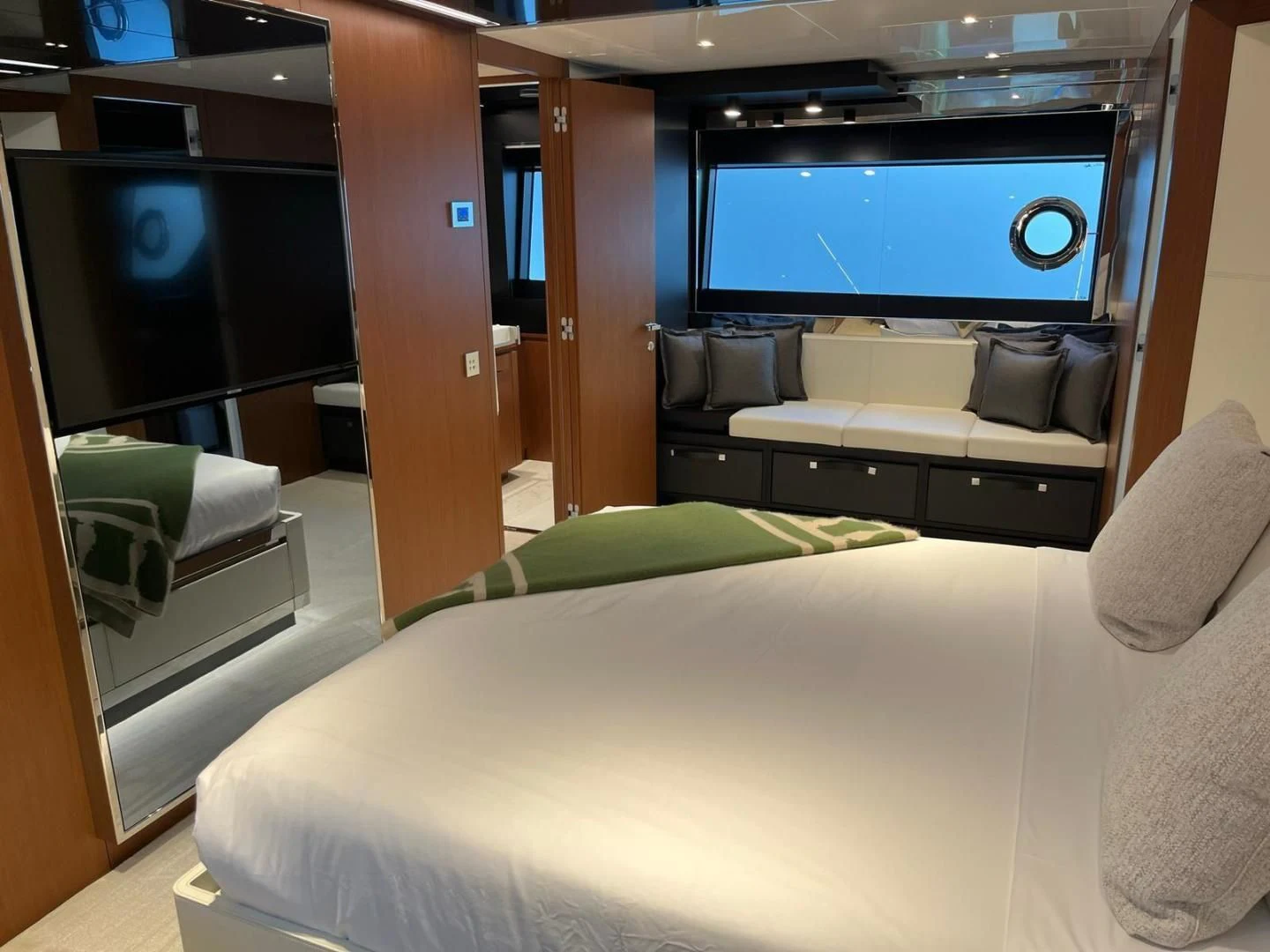 a room with a bed and a tv on the wall aboard KIYOMIZU Yacht for Sale