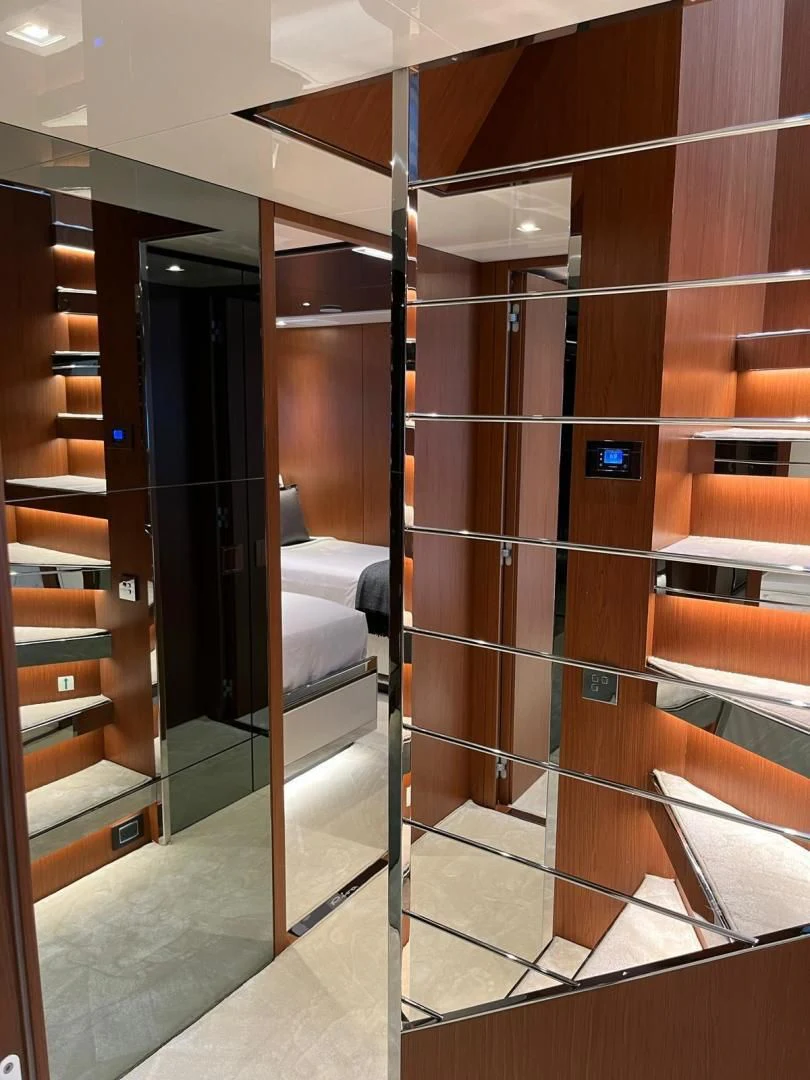 a room with a bed and a mirror aboard KIYOMIZU Yacht for Sale