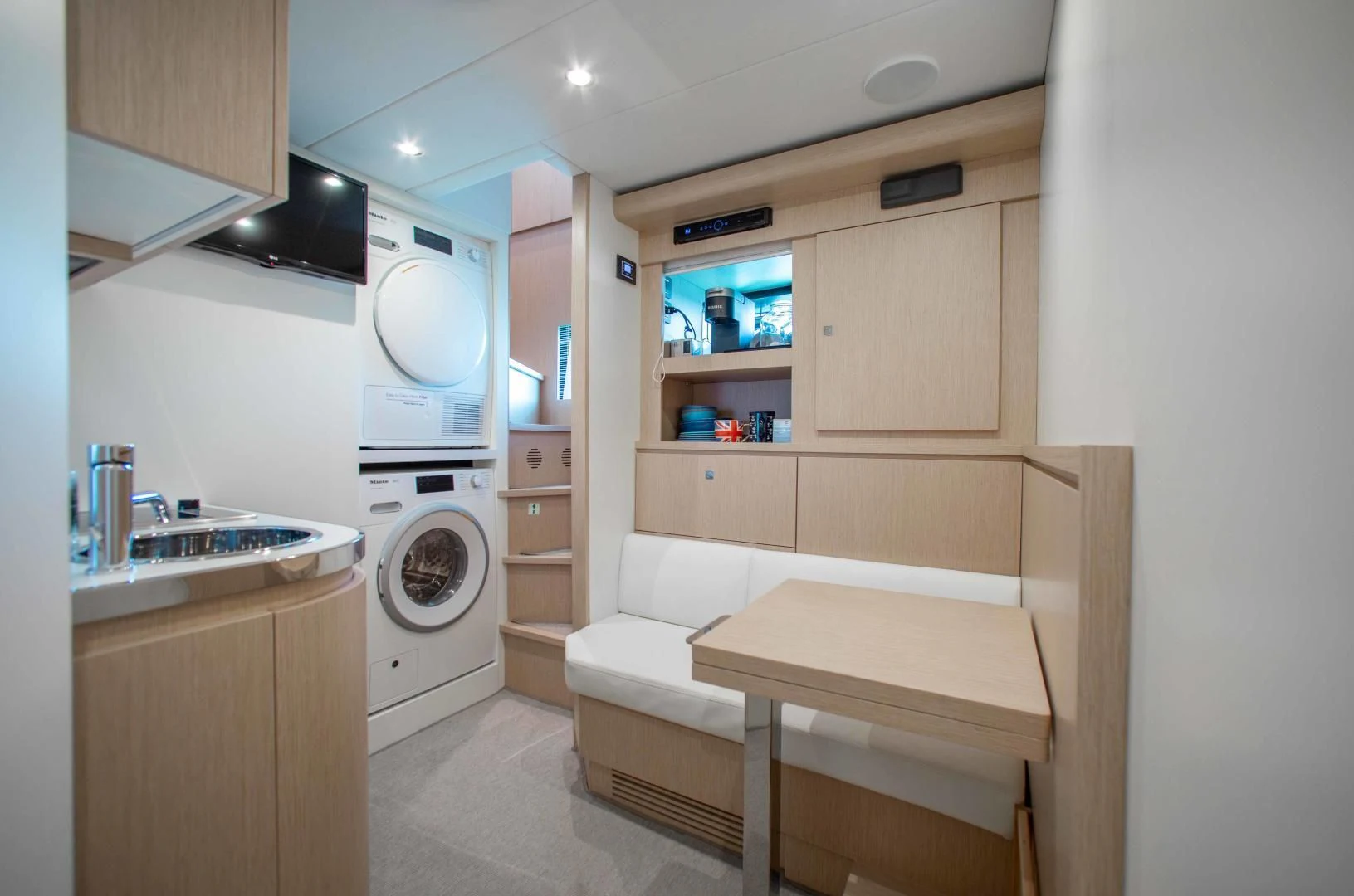 a small room with a bed and a washer aboard KIYOMIZU Yacht for Sale