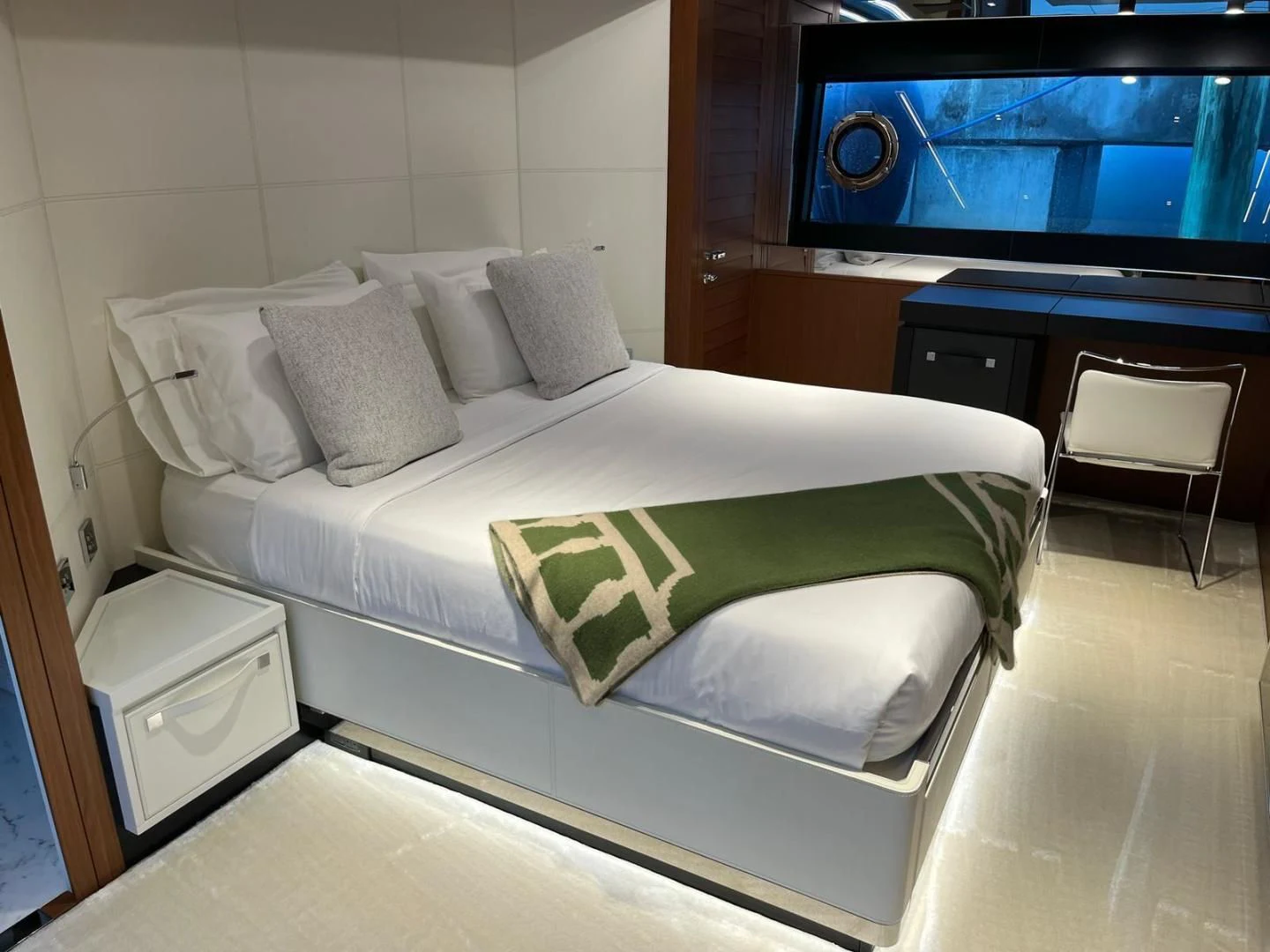 a bed with a green sheet aboard KIYOMIZU Yacht for Sale