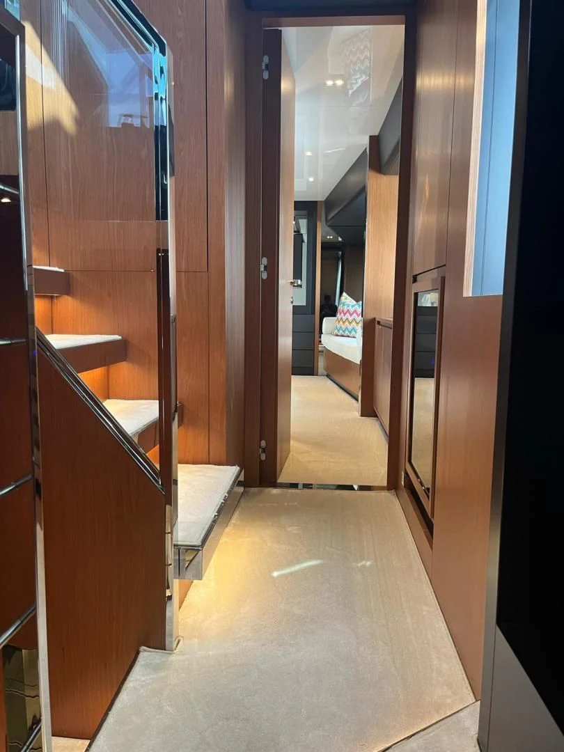 a hallway with a door and a rug on the floor aboard KIYOMIZU Yacht for Sale
