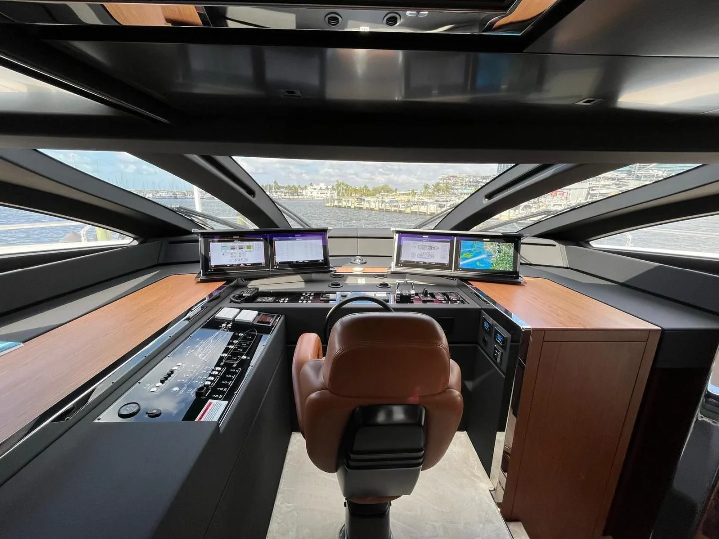 a hand holding a steering wheel aboard KIYOMIZU Yacht for Sale