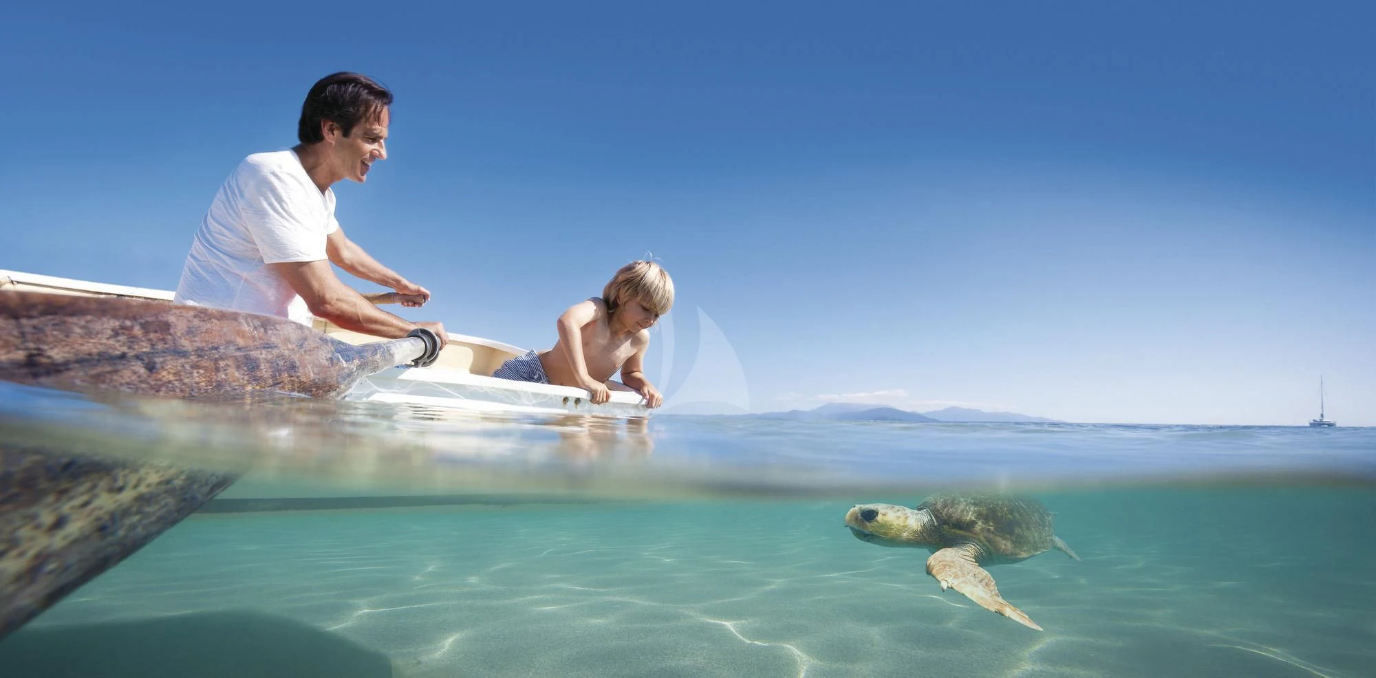 a man and woman on a surfboard in the ocean aboard FLYING FISH Yacht for Sale