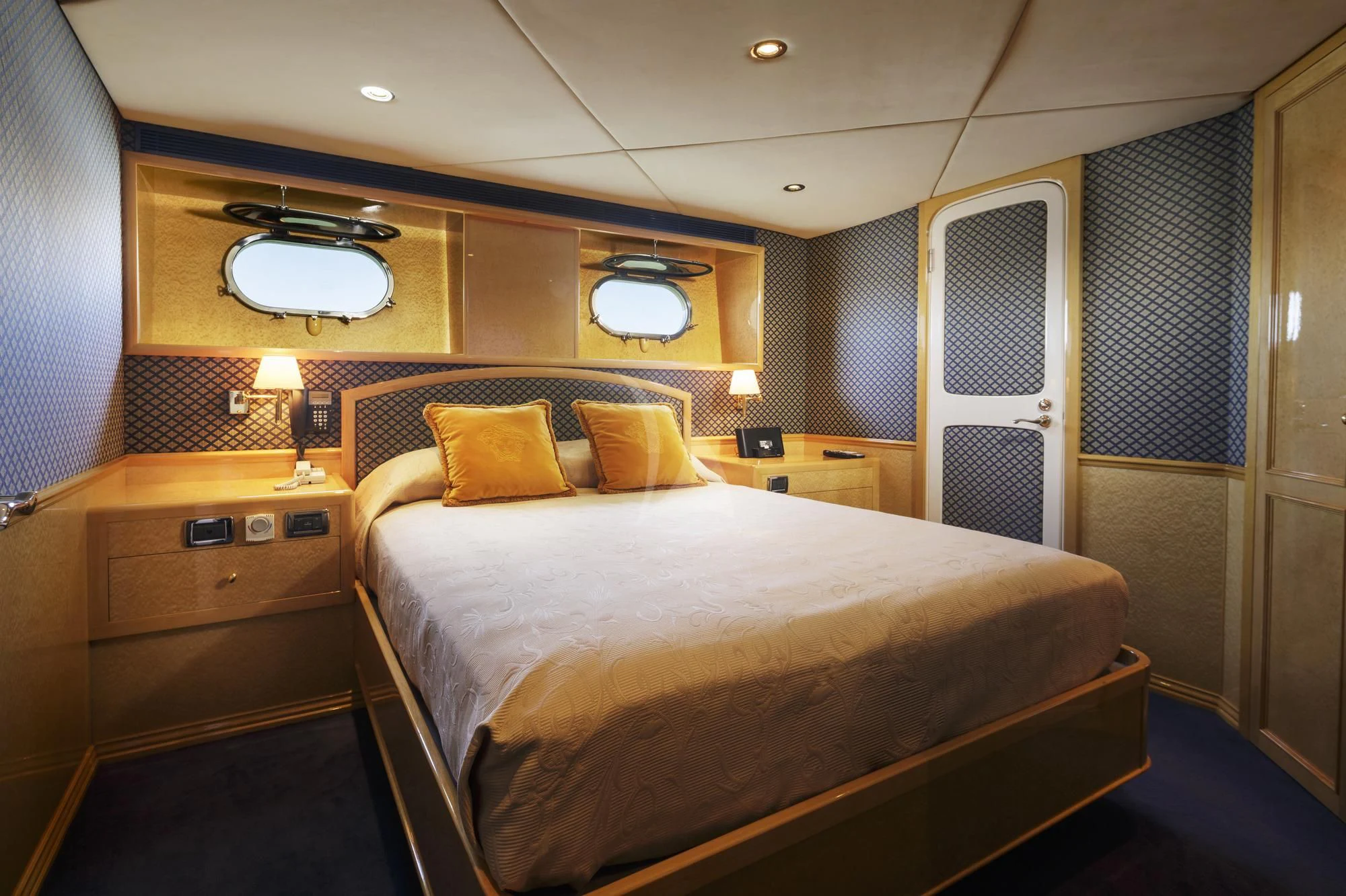 a bed with a white comforter aboard FLYING FISH Yacht for Sale