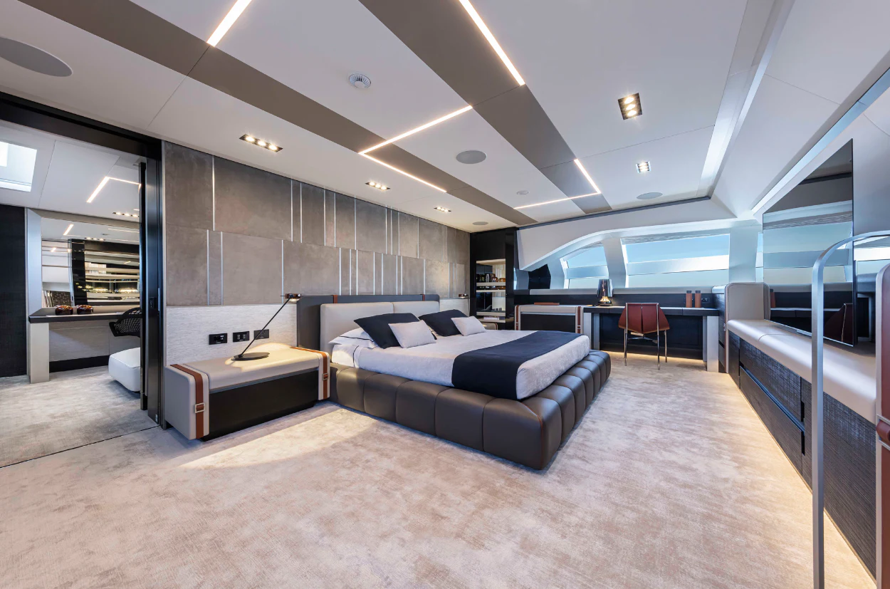 a large room with a bed and a desk aboard PERSHING 140 Yacht for Sale