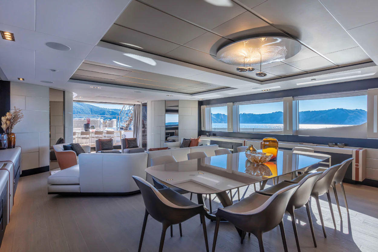 a room with a table chairs and a large window aboard PERSHING 140 Yacht for Sale