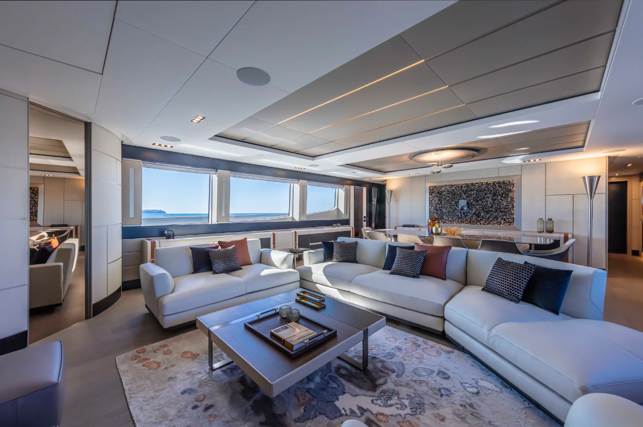 a living room with a couch and a table aboard PERSHING 140 Yacht for Sale