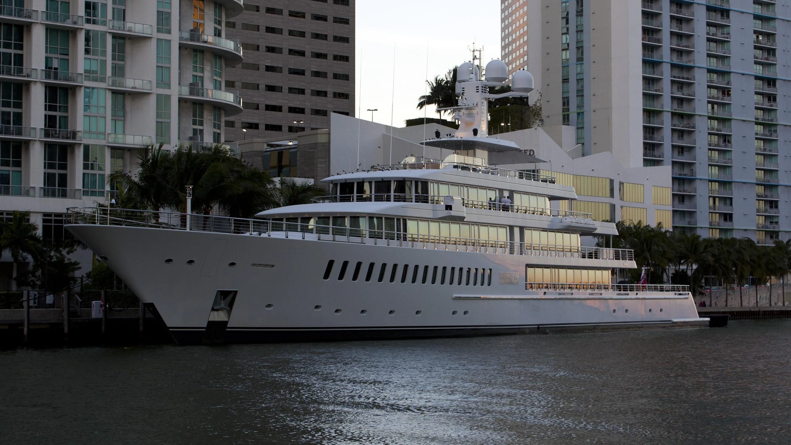 a large white boat in a harbor aboard FOUNTAINHEAD Yacht for Sale