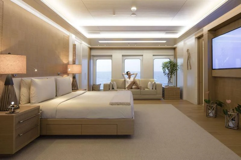 a person sitting on a couch in a large room aboard DYTAN Yacht for Sale