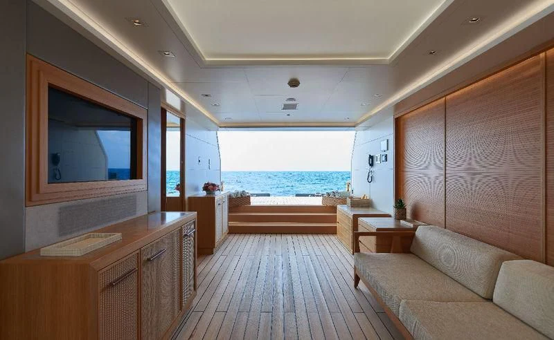a room with a wood floor and a large window with a view of the ocean aboard DYTAN Yacht for Sale