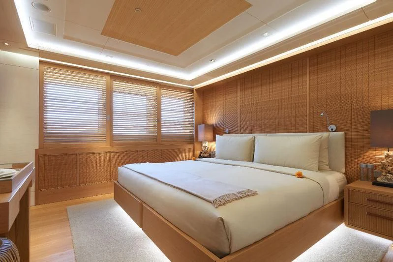 a bedroom with a bed and a window aboard DYTAN Yacht for Sale