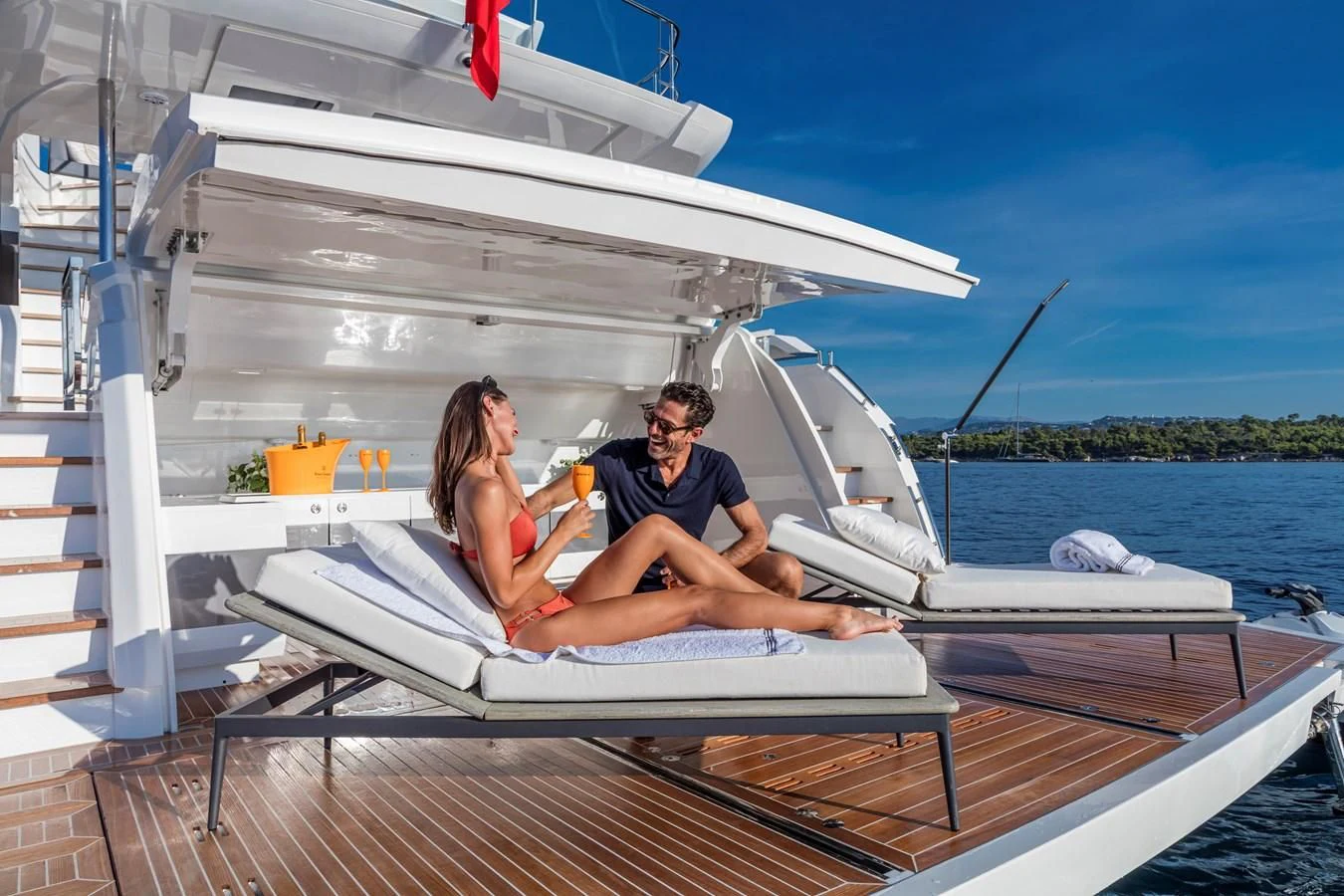a man and woman sitting on a boat in the water aboard AMIRA Yacht for Sale