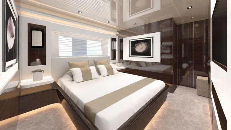 a room with a bed and a television aboard AMIRA Yacht for Sale
