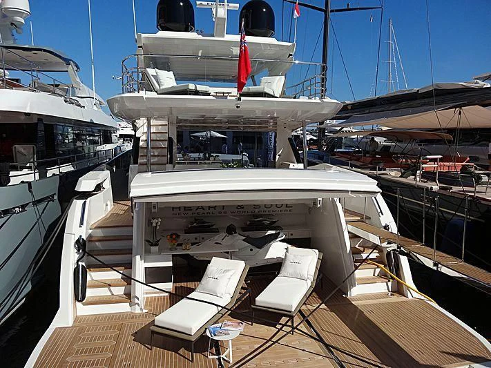 a deck with a deck chairs and a boat on it aboard AMIRA Yacht for Sale