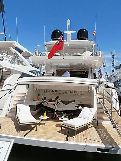 a large white airplane with a red stripe on the front aboard AMIRA Yacht for Sale