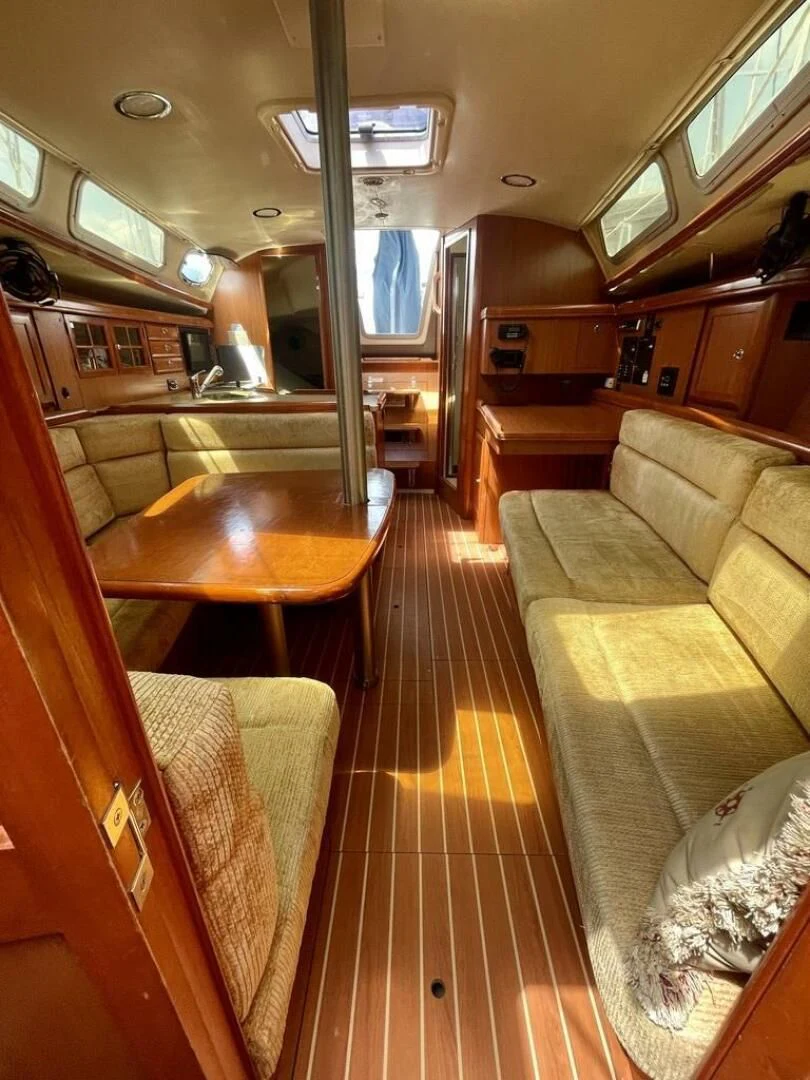 a room with a table and couch aboard ANDIAMO Yacht for Sale