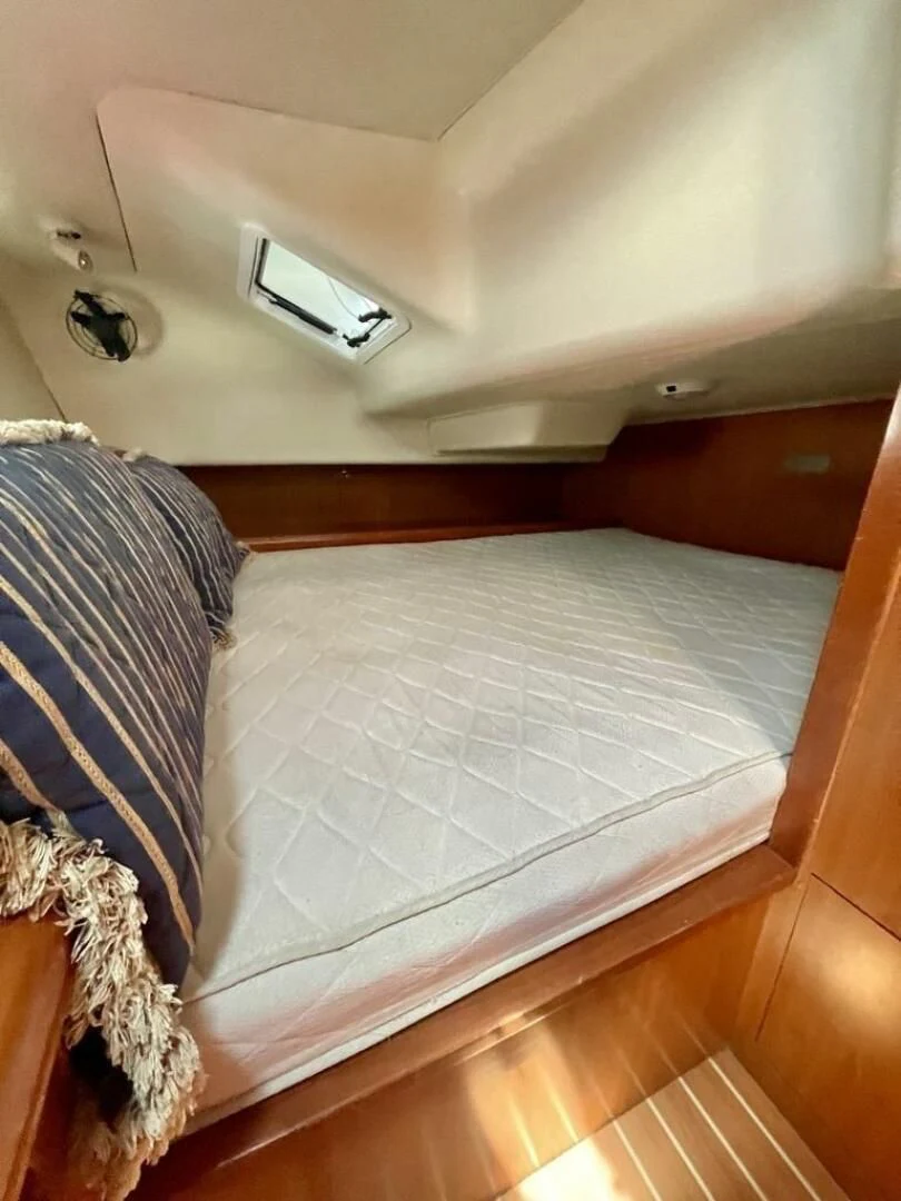 a bed with a white sheet aboard ANDIAMO Yacht for Sale