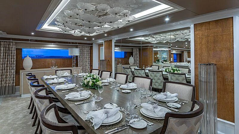 a large dining room with tables and chairs aboard ANDIAMO Yacht for Sale