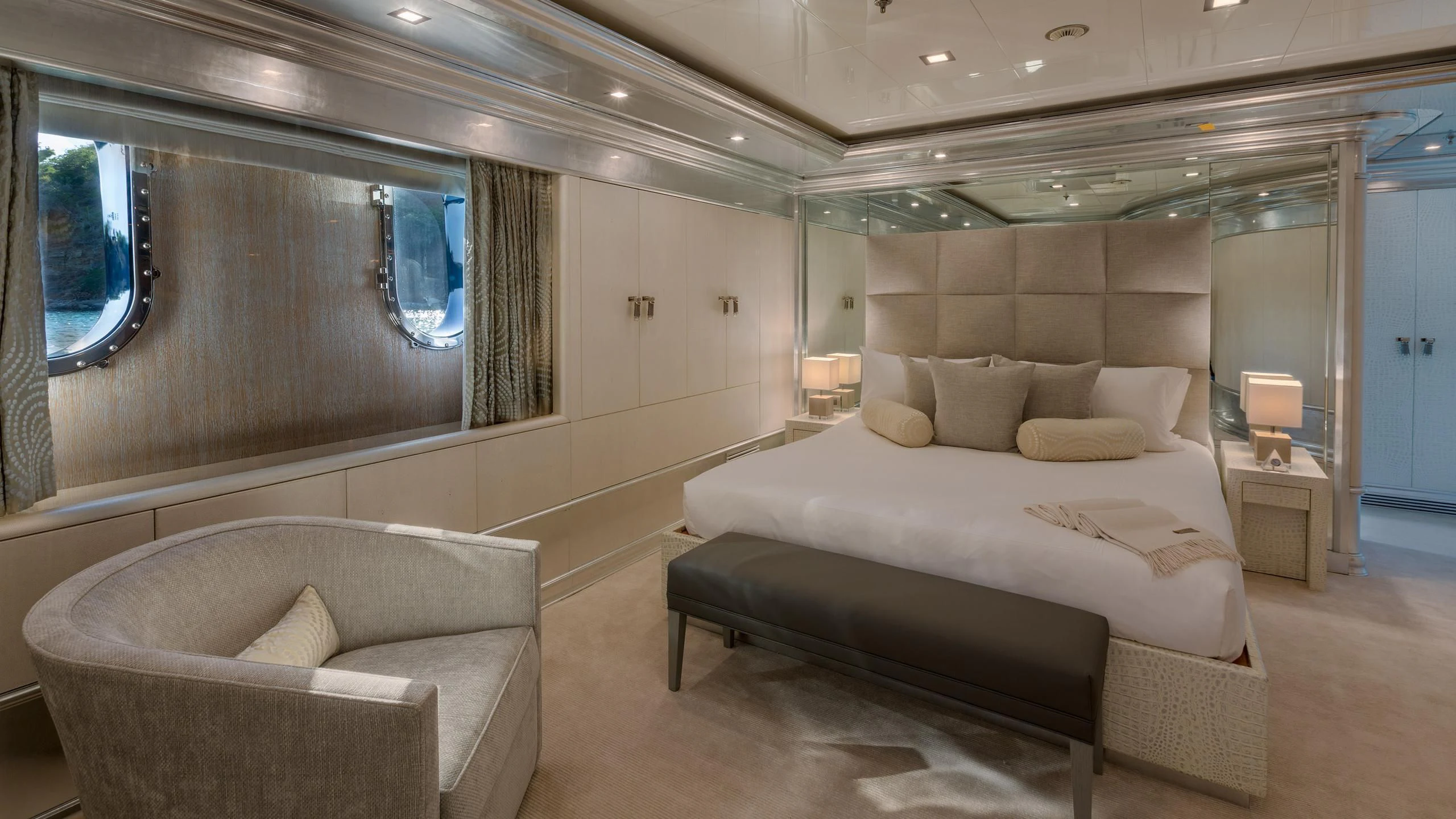 a room with a bed and a chair aboard ANDIAMO Yacht for Sale