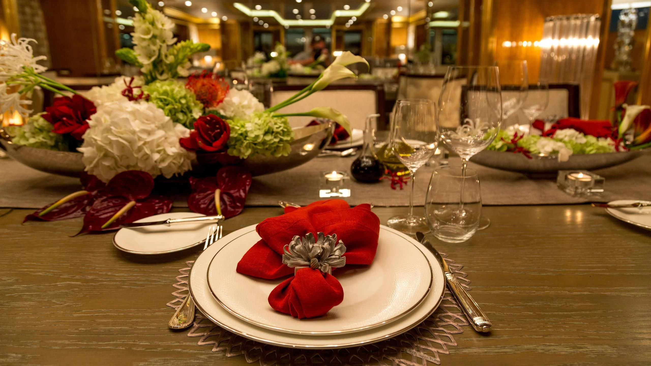 a table with plates and glasses aboard ANDIAMO Yacht for Sale
