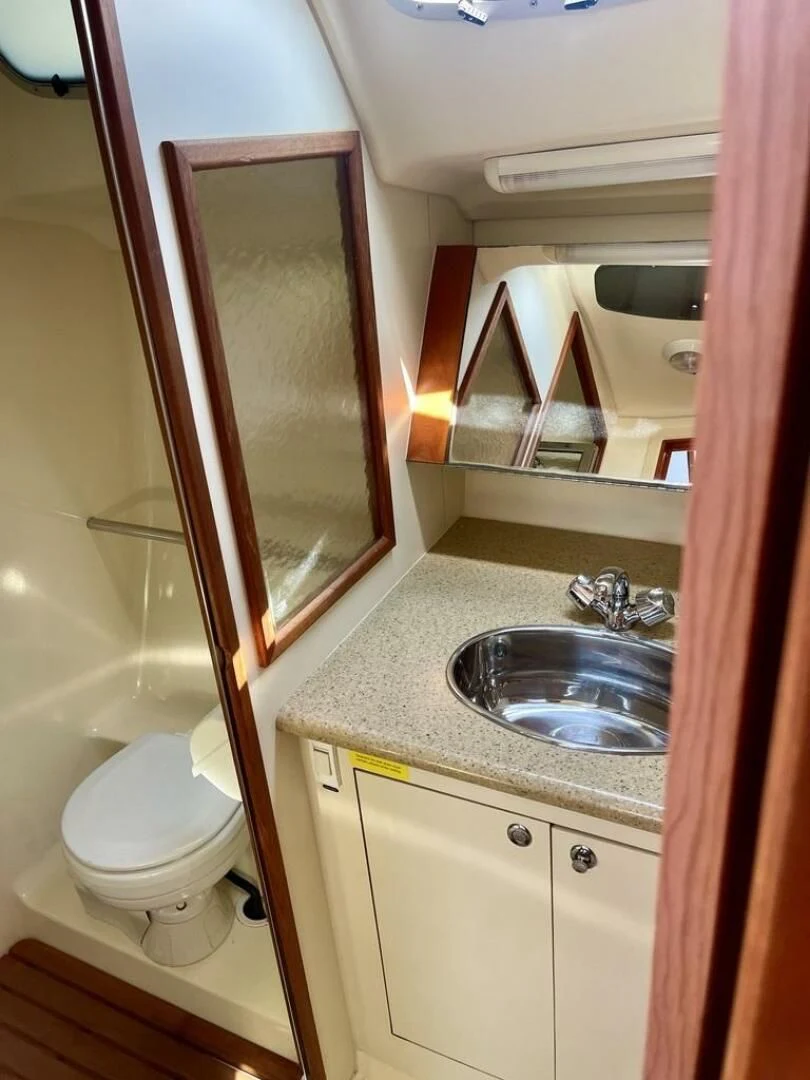 a bathroom with a sink and a toilet aboard ANDIAMO Yacht for Sale