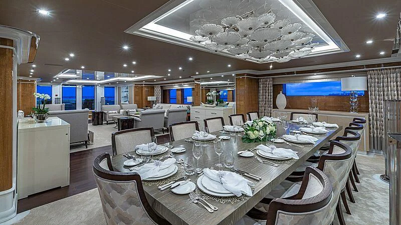 a large room with tables and chairs aboard ANDIAMO Yacht for Sale