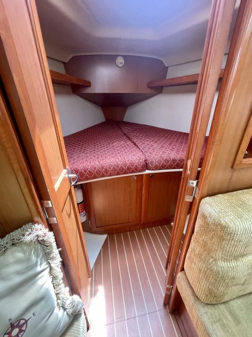 a small room with a bed aboard ANDIAMO Yacht for Sale