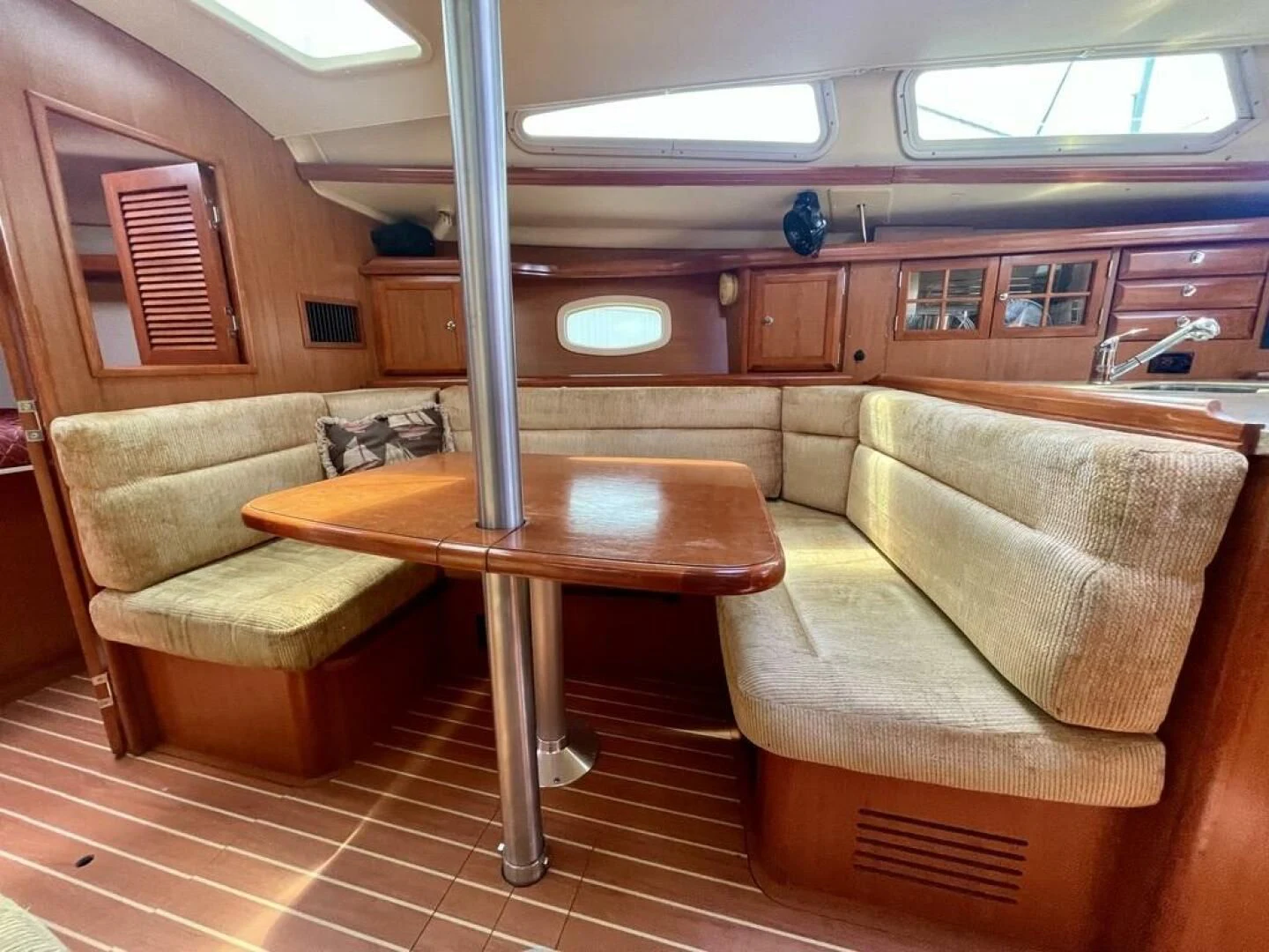 a living room with a table and couches aboard ANDIAMO Yacht for Sale