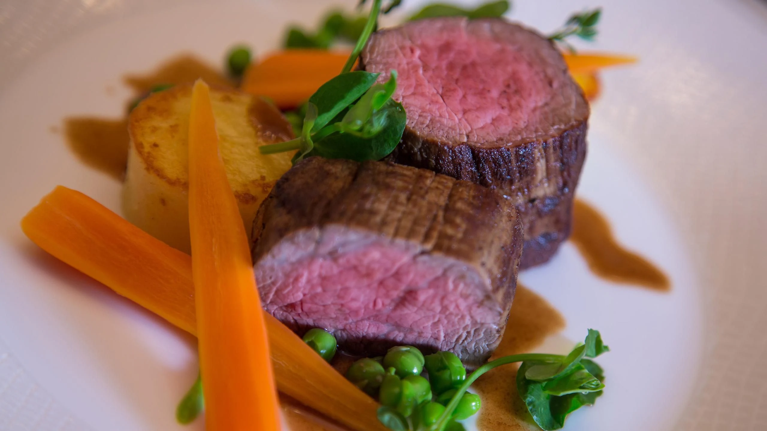 a purple and orange food item with a carrot and a slice of carrot aboard ANDIAMO Yacht for Sale