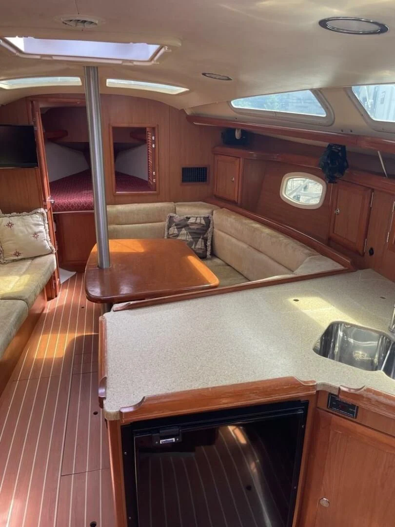 a kitchen with a bar and a couch aboard ANDIAMO Yacht for Sale