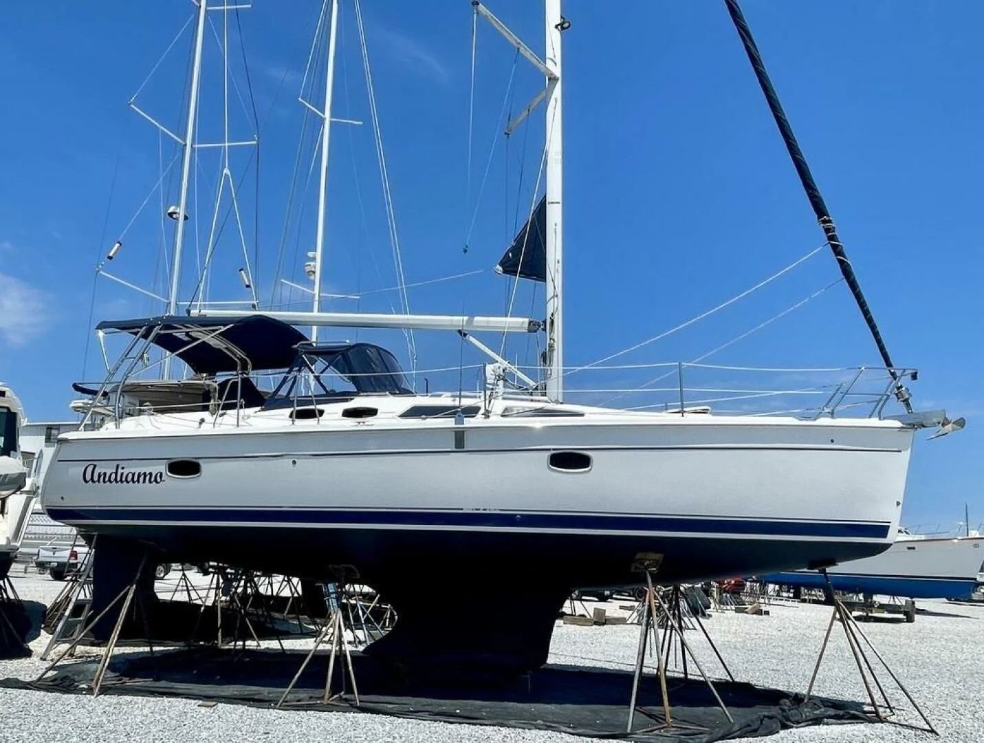 a white boat on a dock aboard ANDIAMO Yacht for Sale