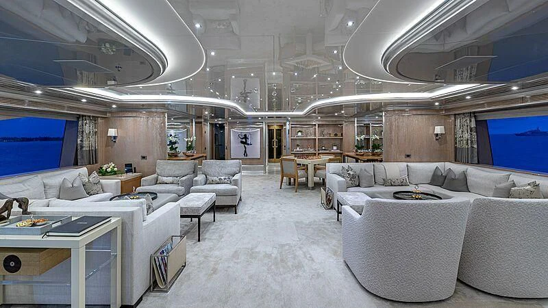 a large room with couches and tables aboard ANDIAMO Yacht for Sale
