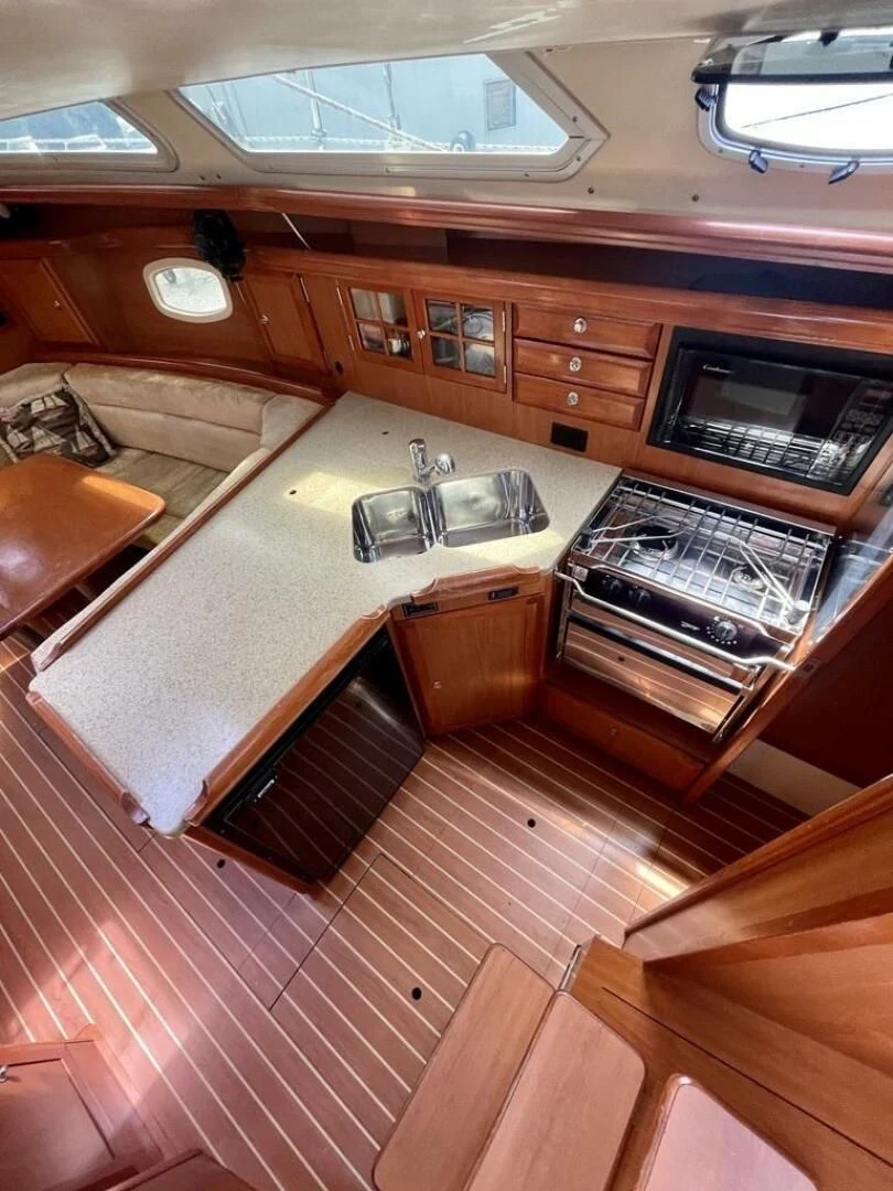 a kitchen with wooden cabinets aboard ANDIAMO Yacht for Sale