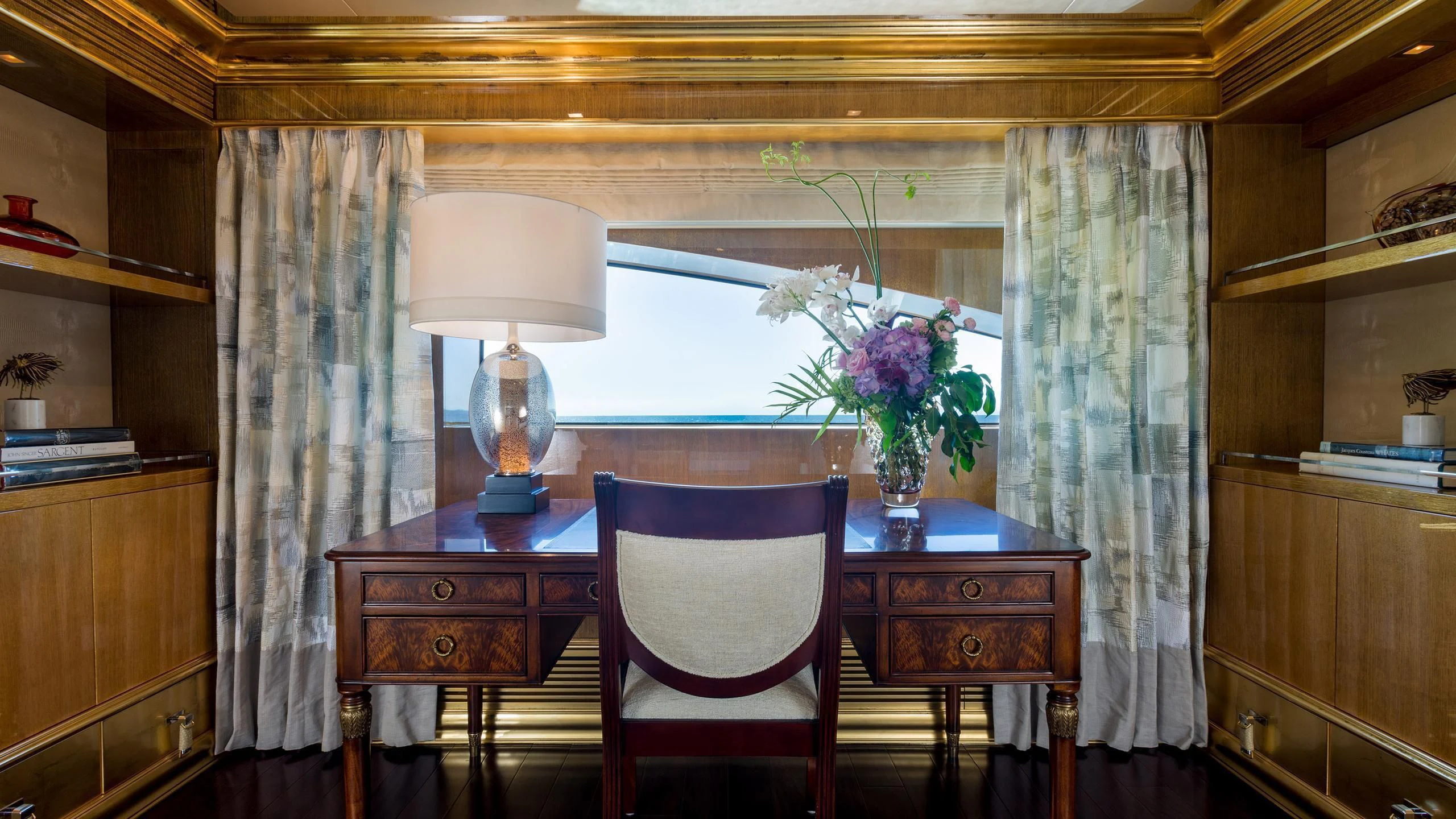 a dining table with a flower vase aboard ANDIAMO Yacht for Sale