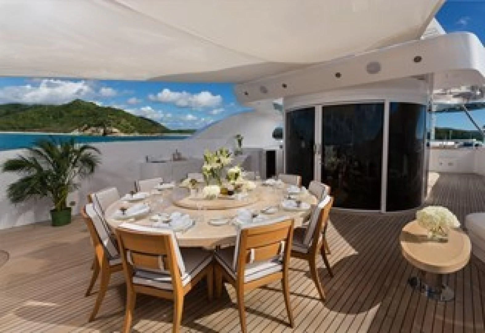 a dining table on a deck aboard ANDIAMO Yacht for Sale